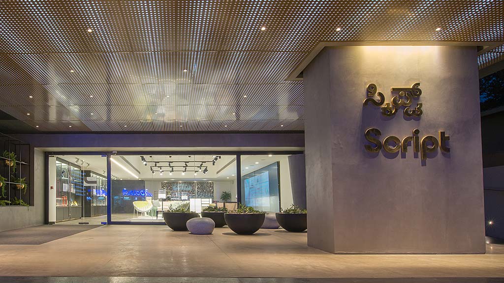 A building with a sign and plants.