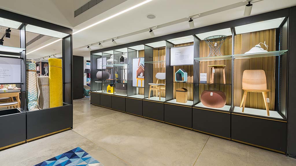 A room with a glass wall and chairs.