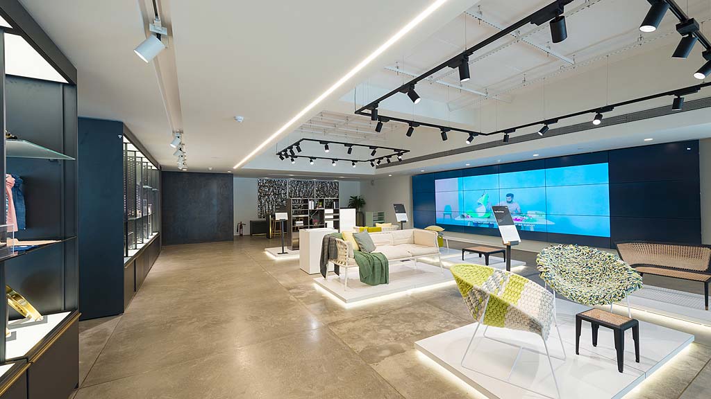 A room with a large screen and chairs.