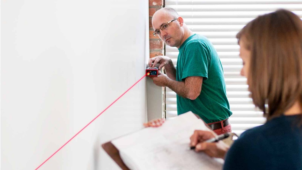 A man drawing on a white board.