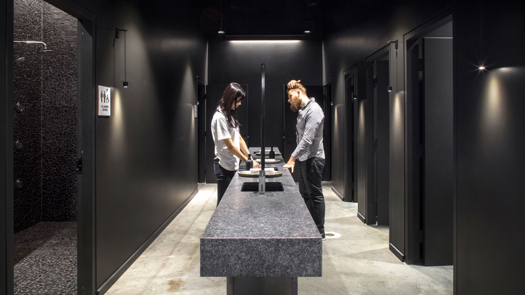 A man and woman standing in a server room.