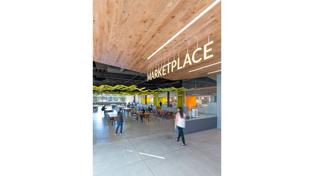 A group of people walking in a mall.