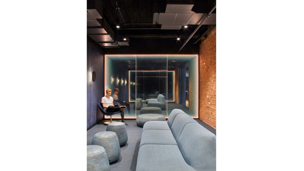 A couple of people sitting in a room with a couch and a table.