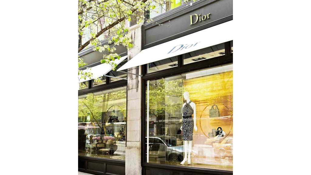 A store front with a mannequin in the window.