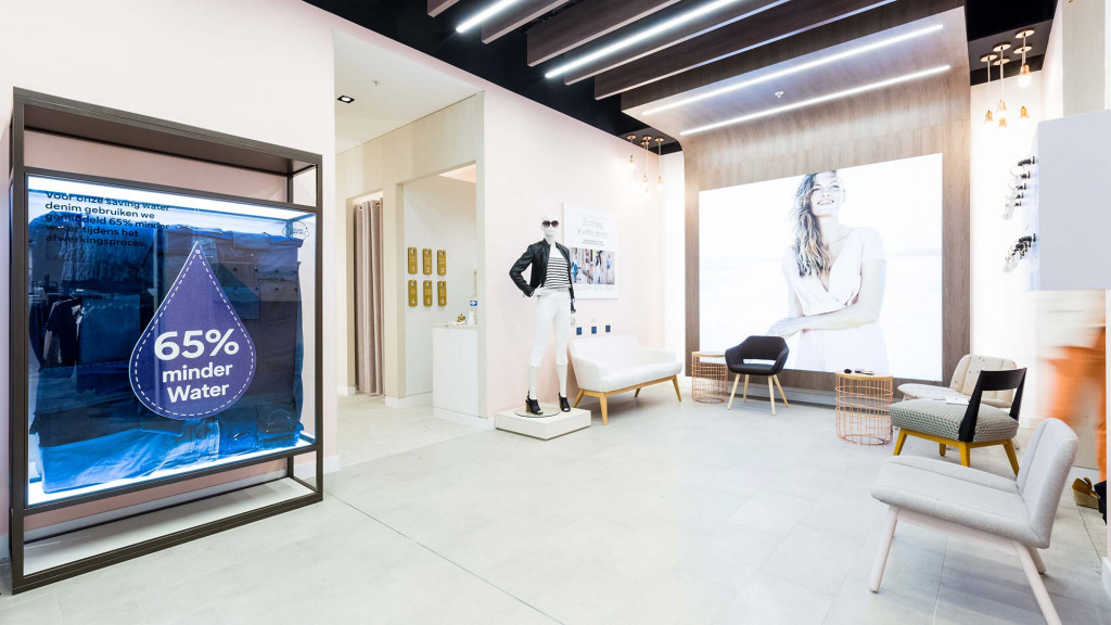 A room with a large screen and chairs.