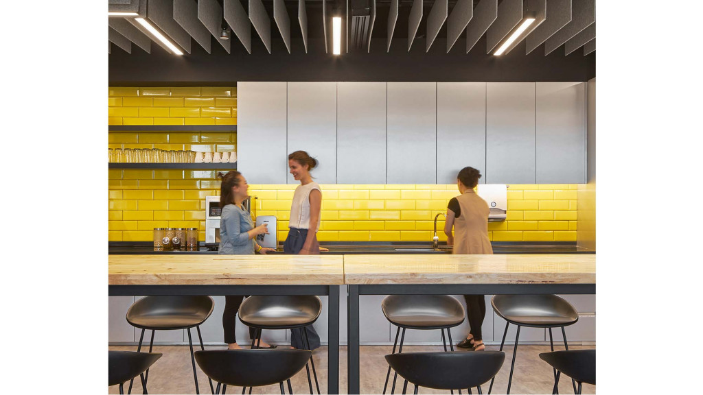 A few people standing at a counter.