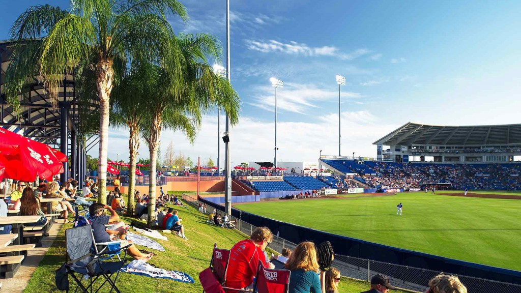 A group of people sitting on a field.