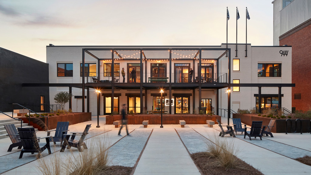 A building with a courtyard and chairs.