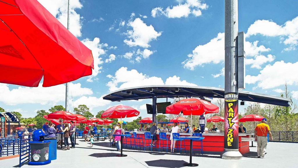 A group of people stand under umbrellas.