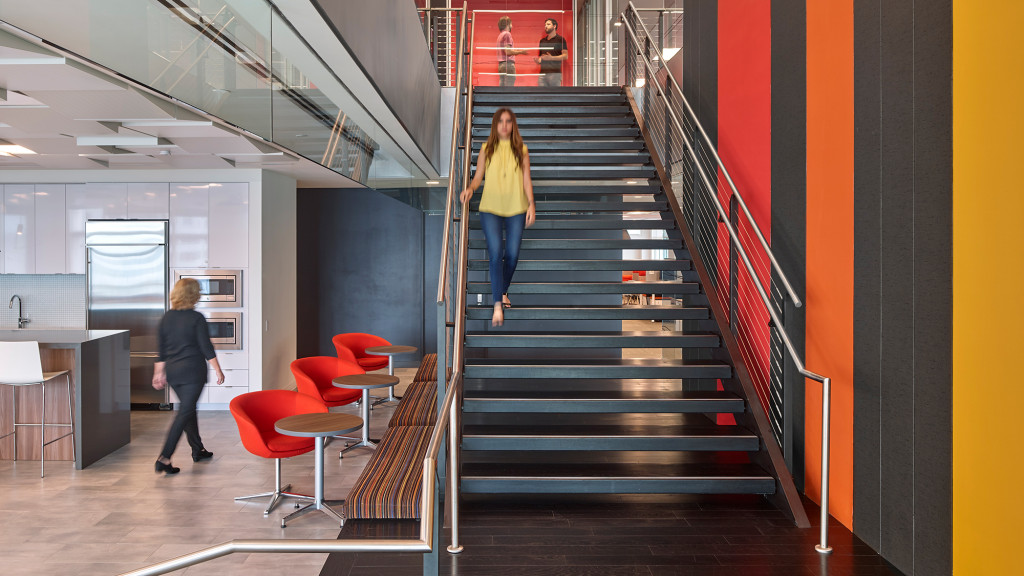 A couple of women walking up a flight of stairs.