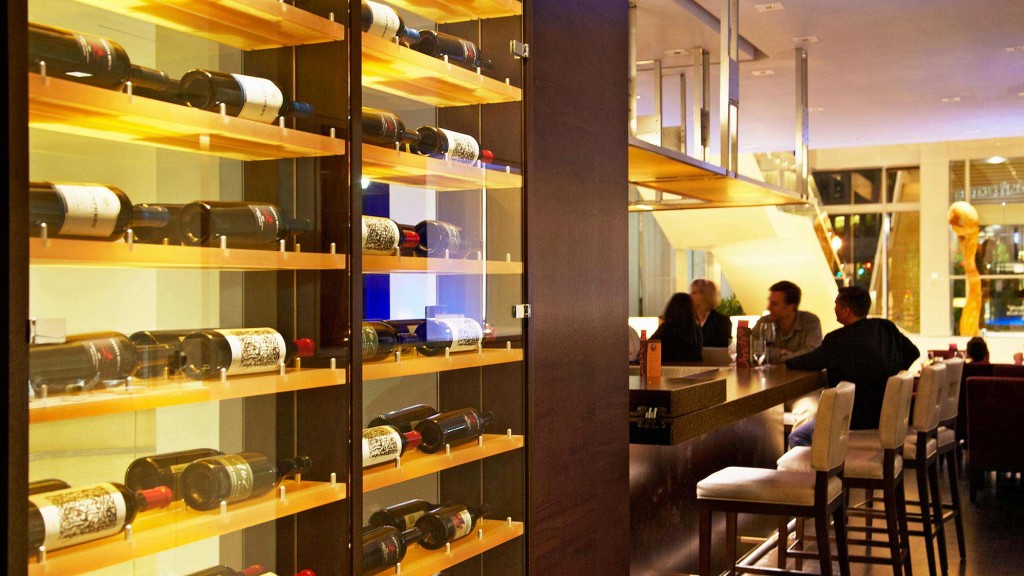 A group of people sitting at a table in a room with shelves.