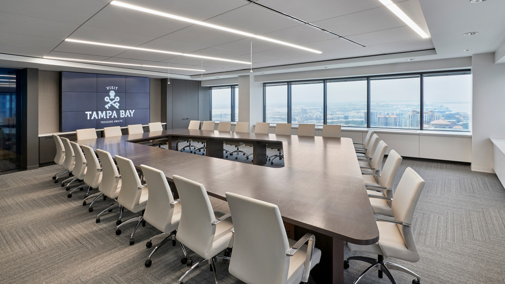 A large conference room with a large table and chairs.
