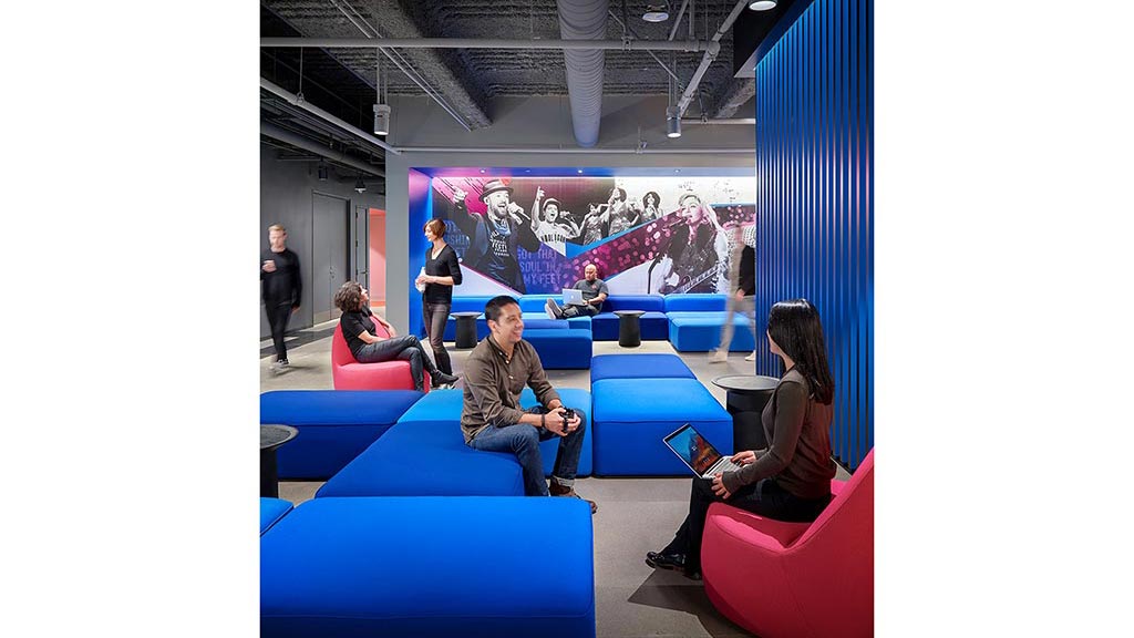 People sitting on blue couches.