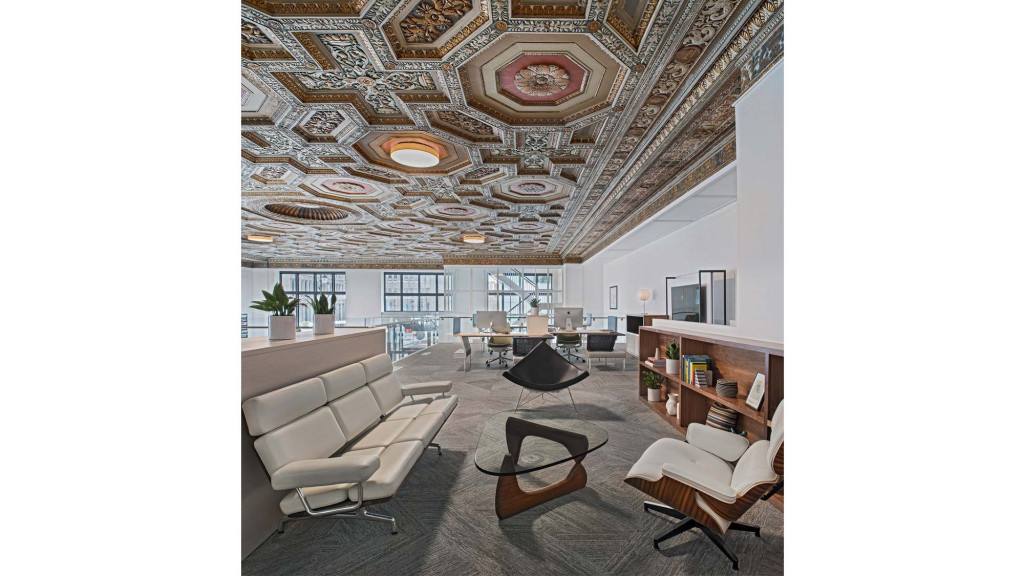 A room with a large chandelier and a large table.