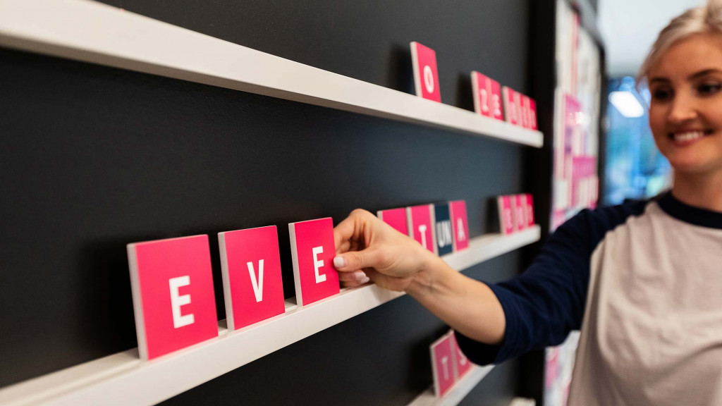 A man pointing to a sign.