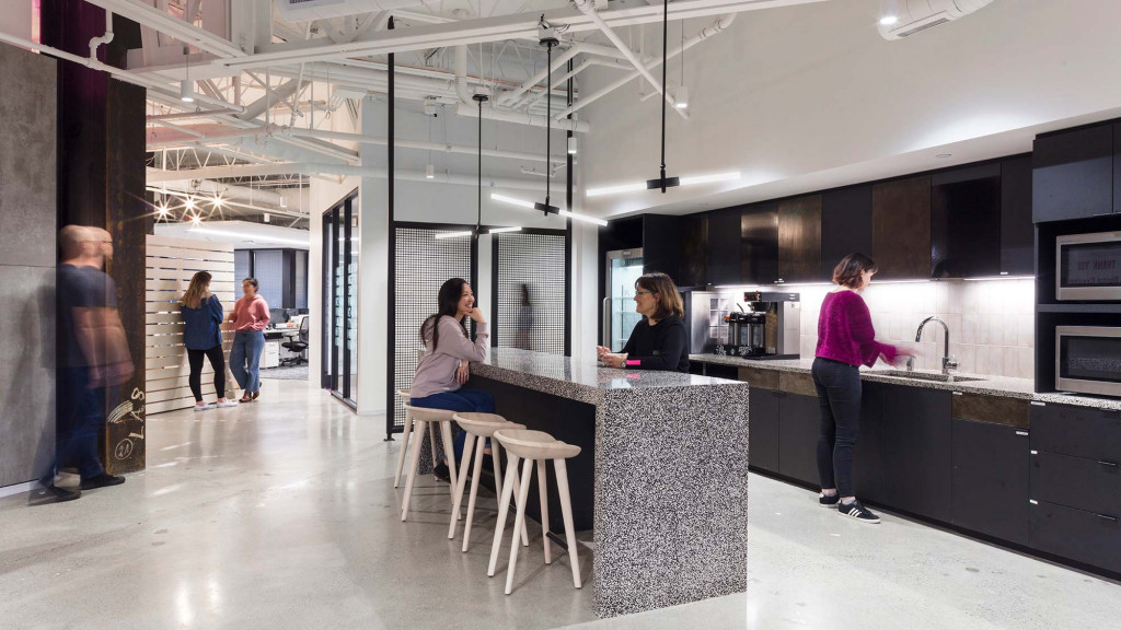A group of people in a kitchen.