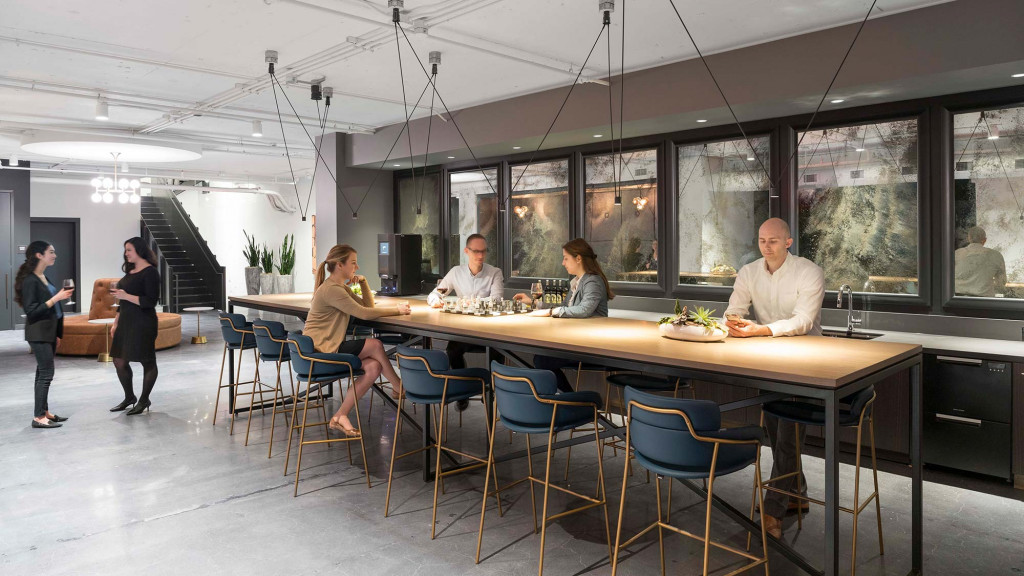 A group of people sitting at a table with food on it.