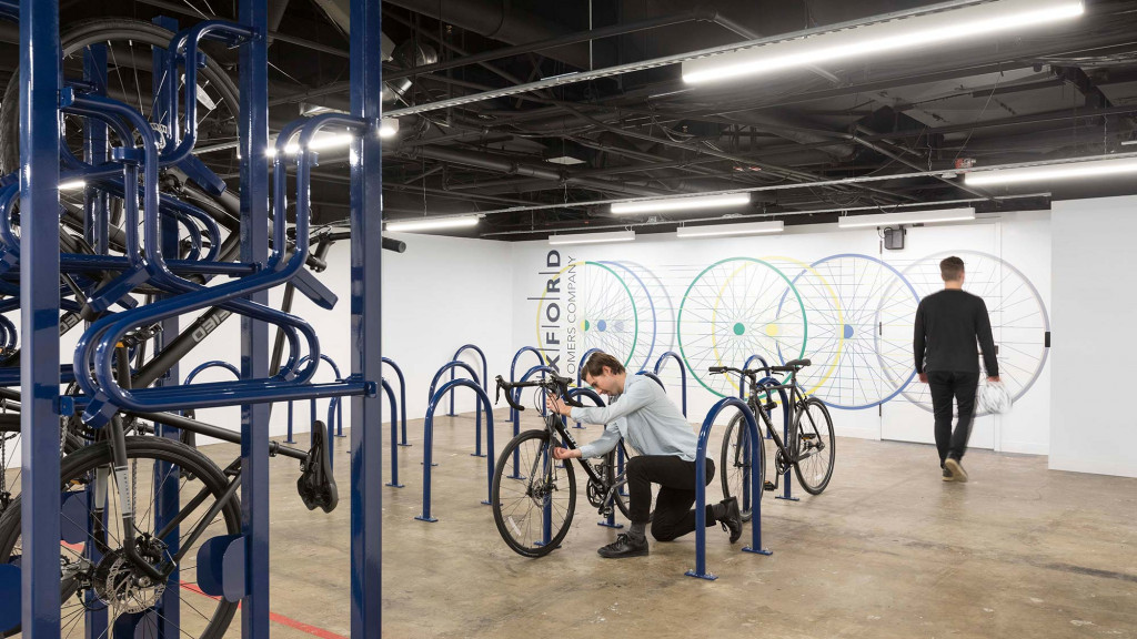 A person working out in a bike shop.