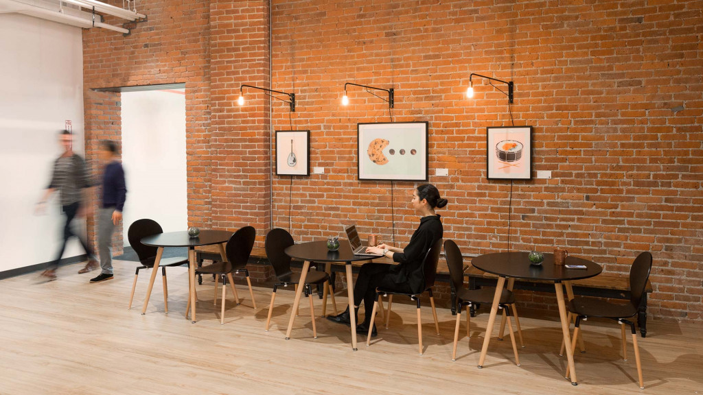 A person sitting at a table with a laptop.