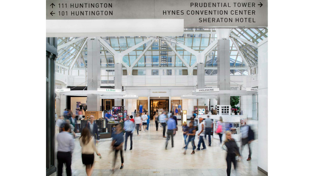 A group of people walking in a large building.
