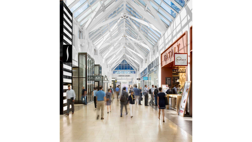 A group of people walking through a building.