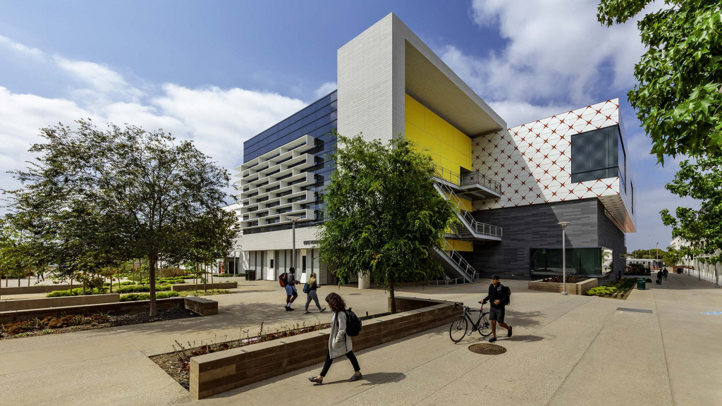 A building with a few people walking around.