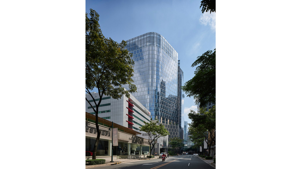 A street with trees and buildings on the side.