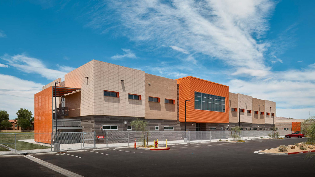 A large building with a parking lot.