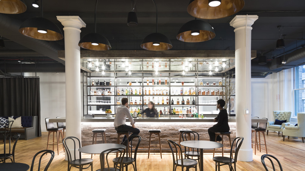 A group of people sitting at a bar.