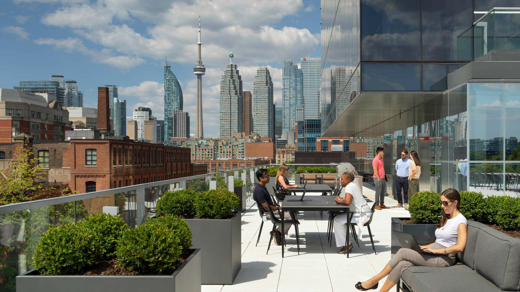 People sitting at a table in front of a city.
