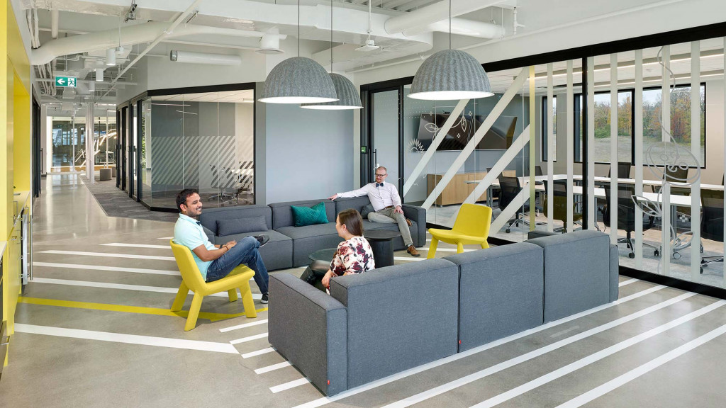 A group of people sitting on a couch in a building.