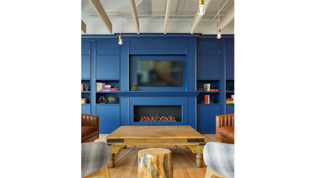 A room with a fireplace and a table.