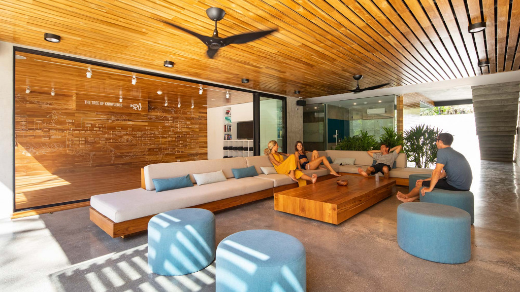 A group of people sitting on a couch in a living room.