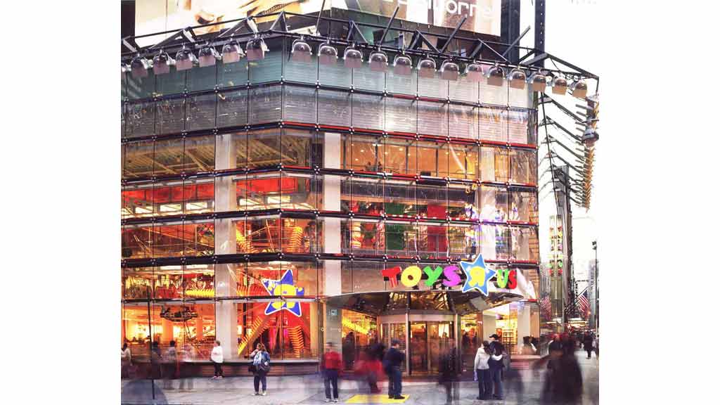 A building with many windows and people walking around.