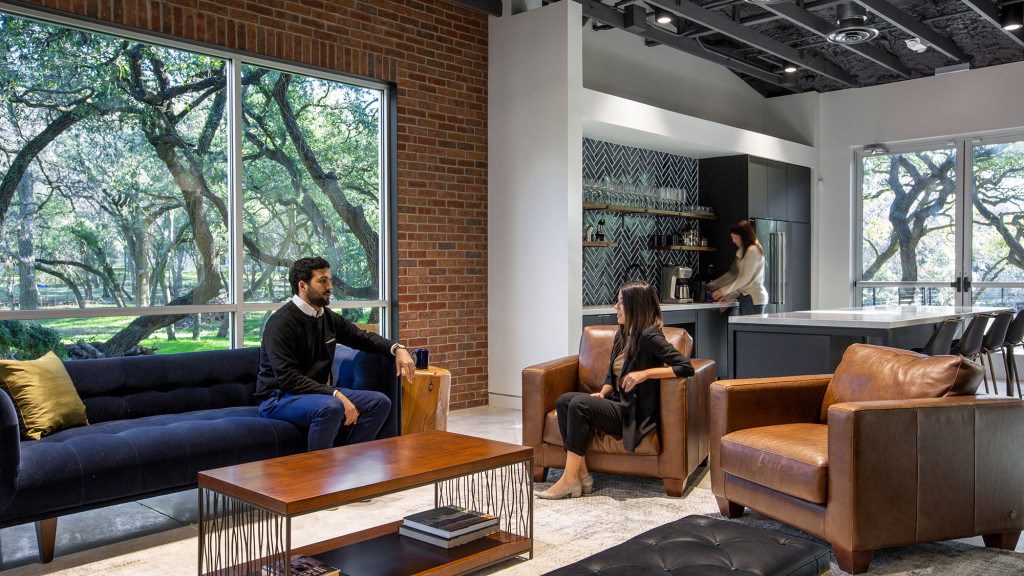 A man and woman sitting in a living room.