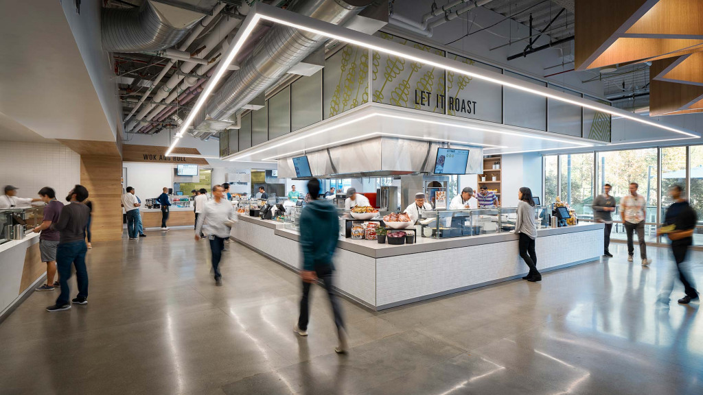 A group of people in a large room with a large glass ceiling.