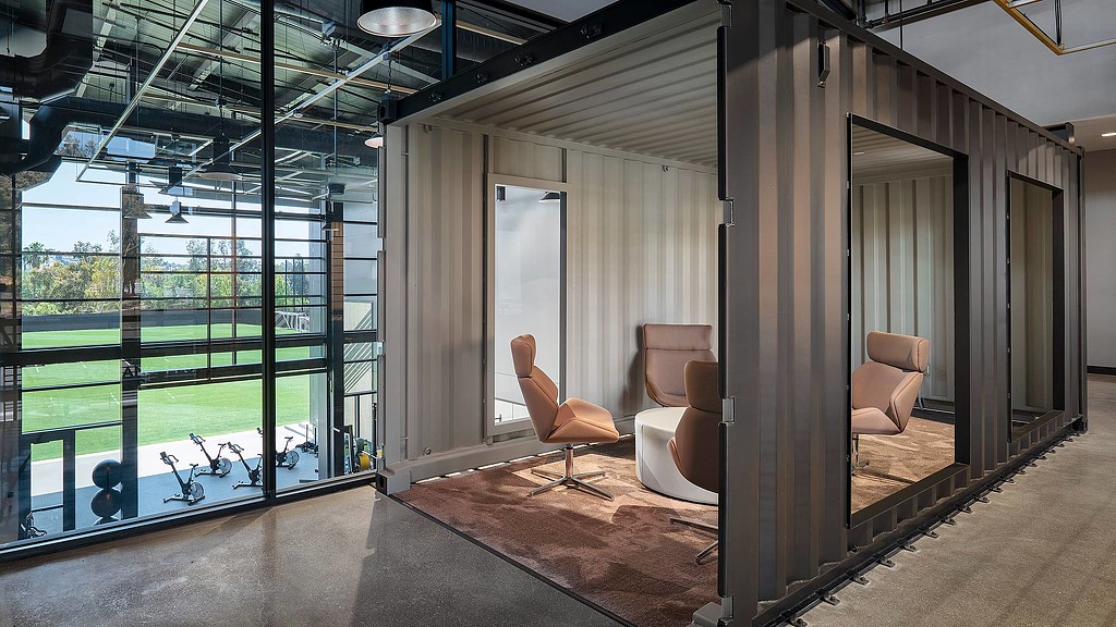 A room with a glass wall and a glass railing.