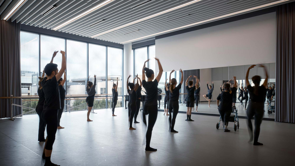 A group of people exercising in a room.