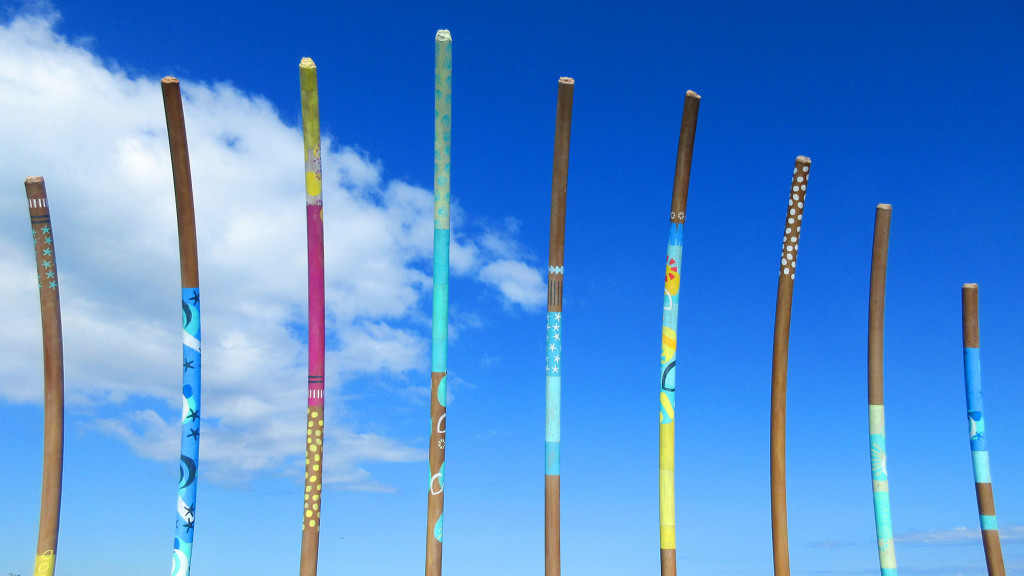 A group of poles with different colored sticks.