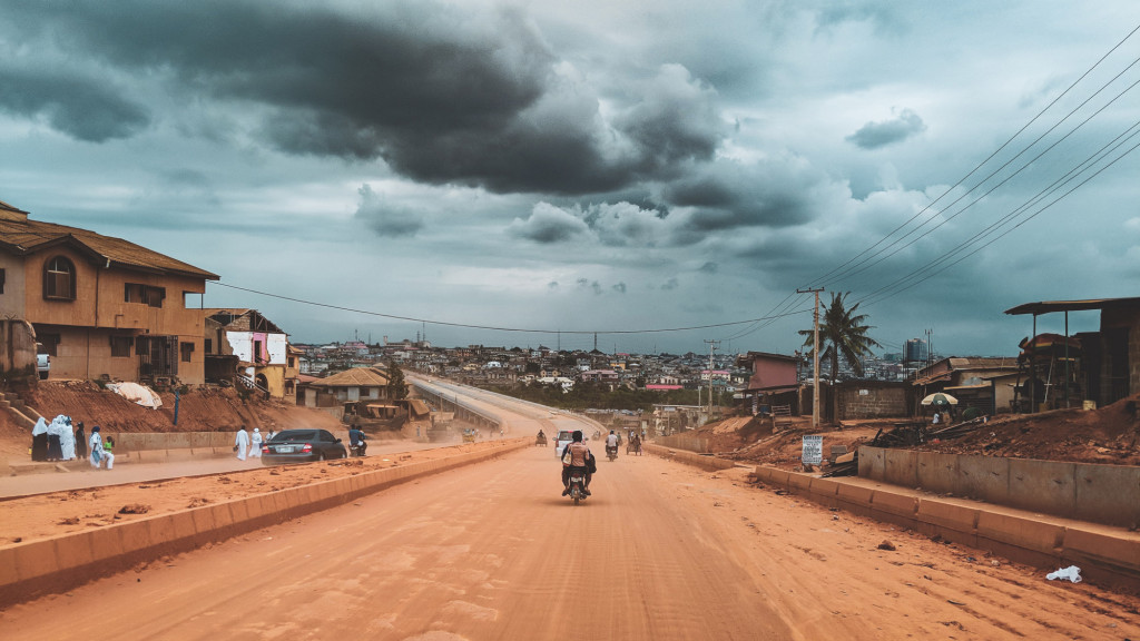 A dirt road with buildings on either side of it.
