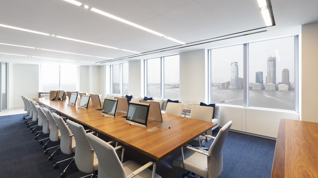 A large conference room with a large table and chairs.