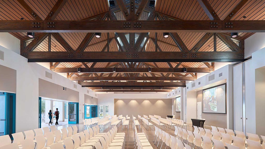 A room with rows of white chairs.
