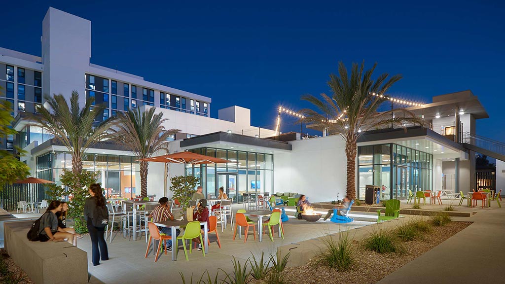 A group of people sitting outside a building.