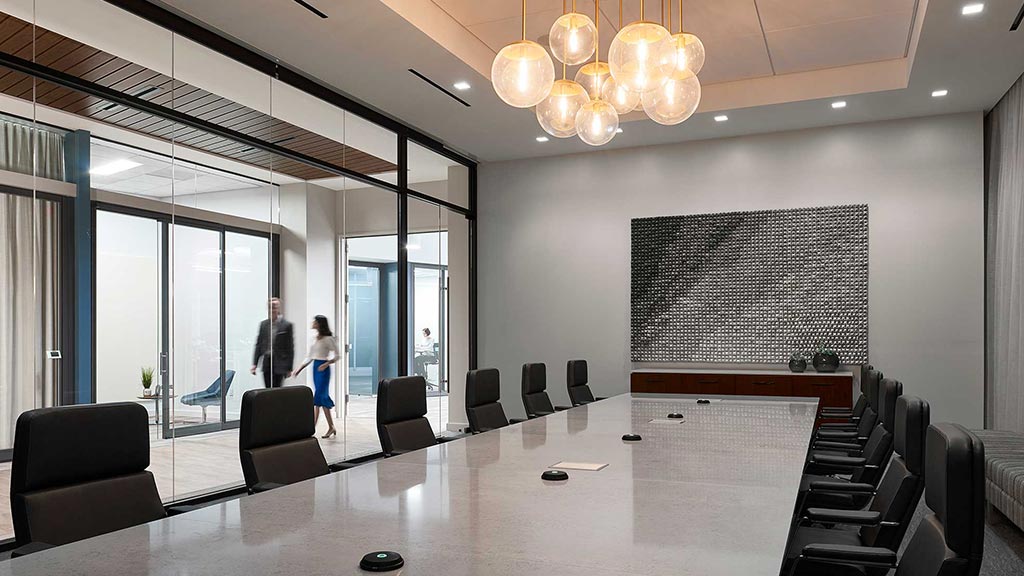 A large room with a large white table and chairs.