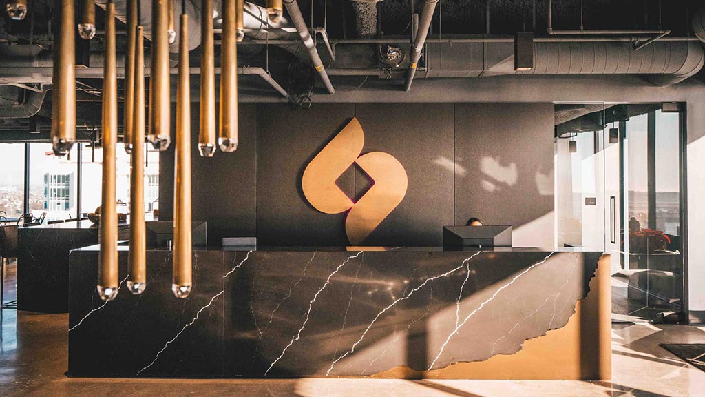 A large room with pipes and a wall with a logo on it.