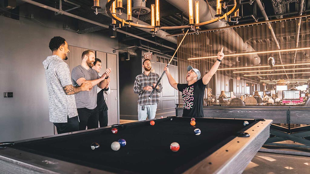 A group of men playing pool.