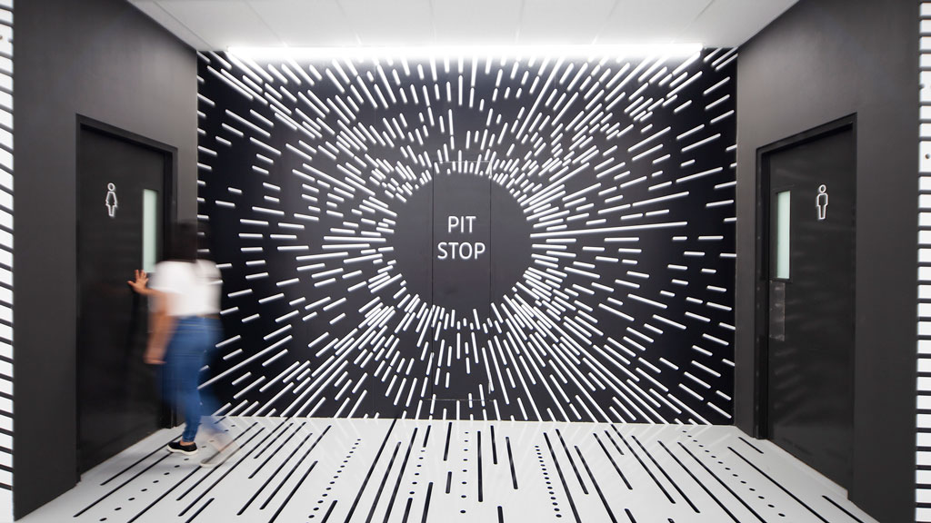 A person looking at a large black and white sign.