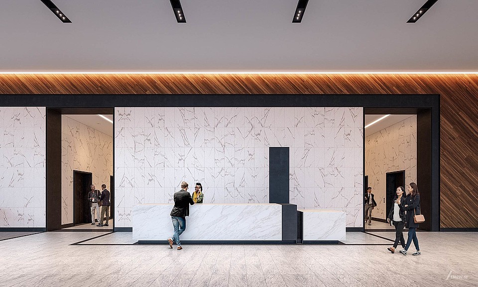 A group of people stand in a large room.