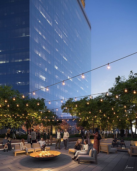 A group of people sitting on benches in front of a building.