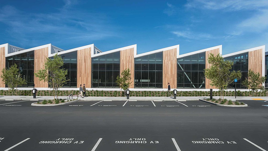 A large building with a parking lot.